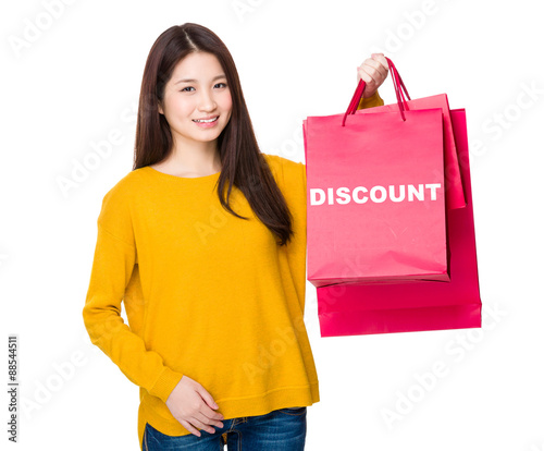 Woman hold with shoppong bag showing a word discount photo