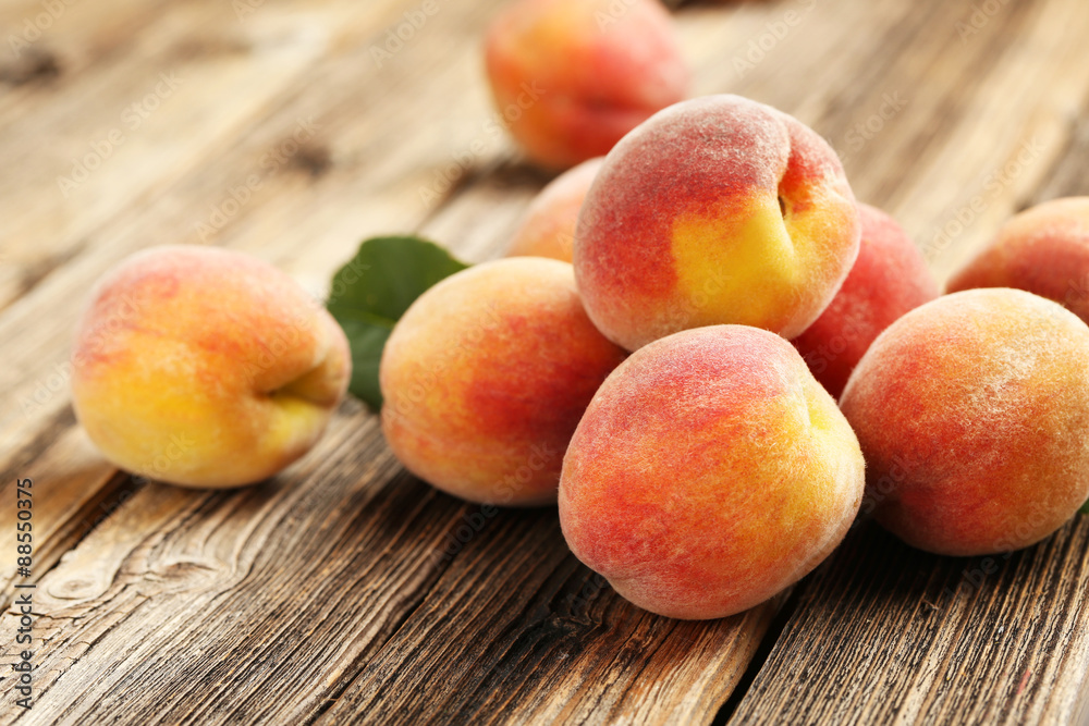 Ripe peaches fruit on a brown wooden background Ripe peaches fruit on a brown wooden background