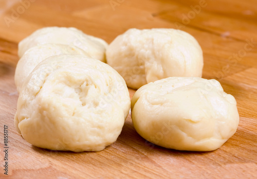 Pieces of dough on a wooden board