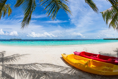 colorful boats on wonderful beach under coco palms