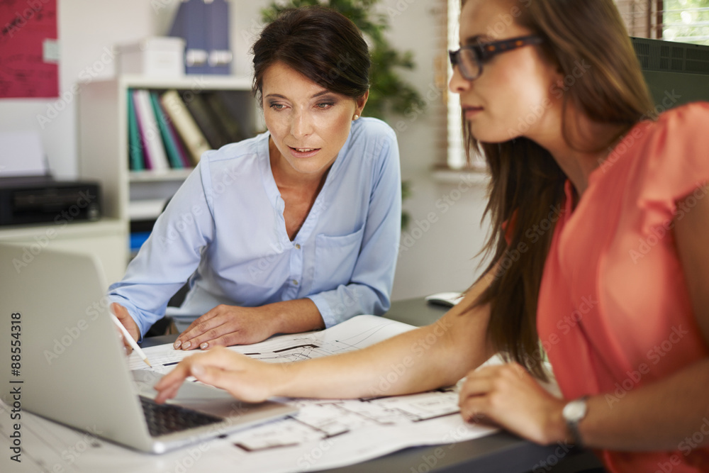 Two women consulting data on the computer Two women consulting data on the computer