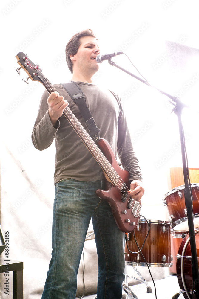 Fototapeta premium Rock musician playing bass on stage.