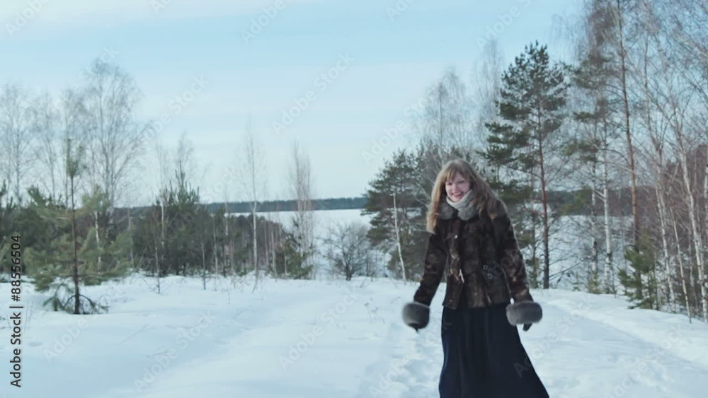 Couple having snowball fight in snow in winter forest Couple having snowball fight in snow in winter forest