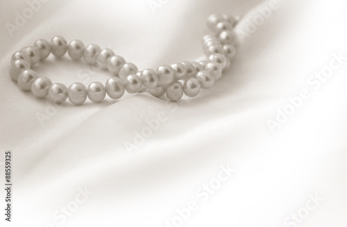 Elegant beige background with lace, silk and pearls
