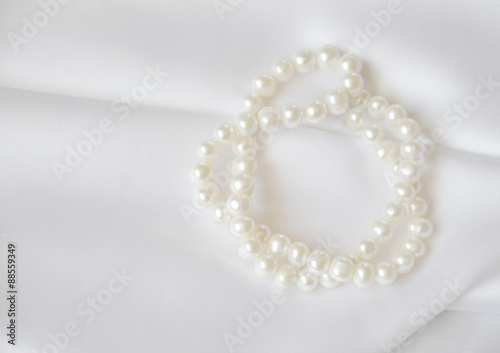 Elegant white background with lace, silk and pearl