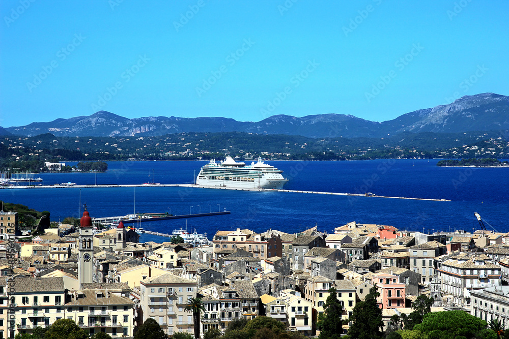 Panorama of the old town. Old town and sea view. White sea liner in the sea bay. Ionian sea. Corfu town. Kerkyra. Greece island