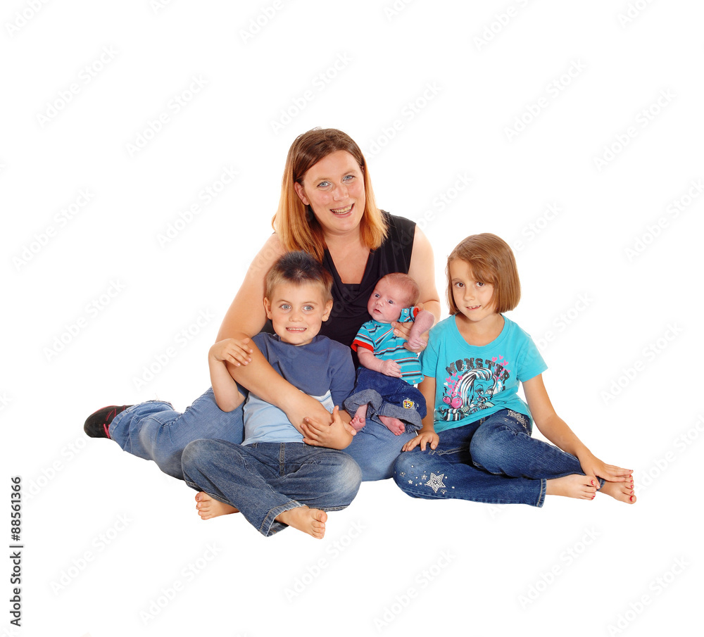 Mother with her three kids sitting on floor. Mother with her three kids sitting on floor.