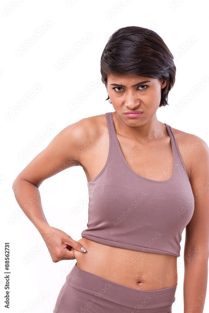 unhappy woman with hand holding excessive belly fat, isolated on unhappy woman with hand holding excessive belly fat, isolated on