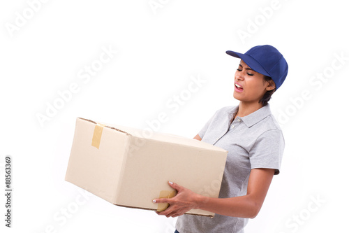 female delivery staff carrying heavy parcel carton box © 9nong