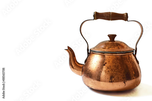 Old copper teapot isolated on white background photo
