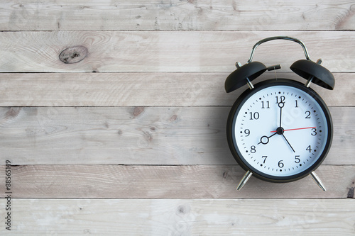 Alarm clock isolated on wooden floor