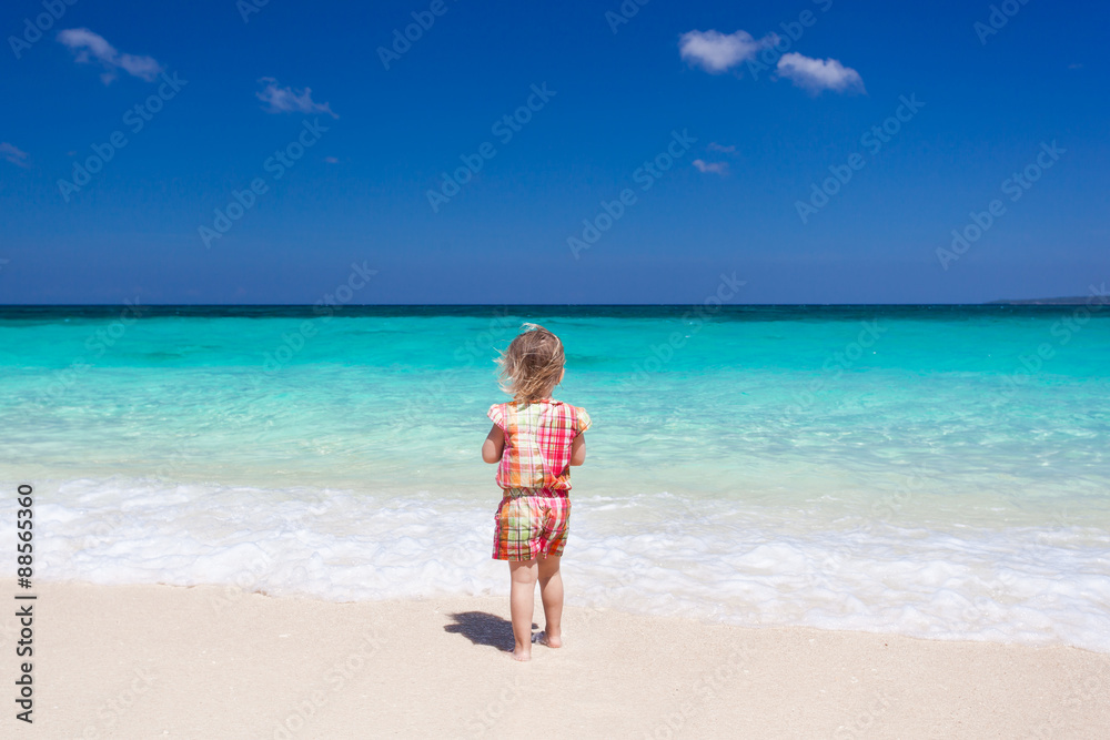 Happy little girl on the beach