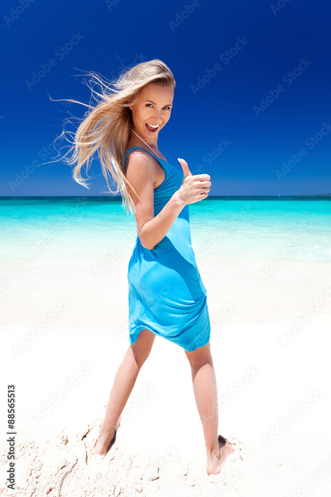 Happy blond girl on beach, showing okey sign. Happy blond girl on beach, showing okey sign.