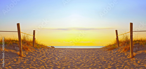 Fotografia, Obraz Path on the sand going to the ocean in Miami Beach Florida at sunrise or sunset,