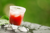 Red cocktail with ice and sugar, selective focus