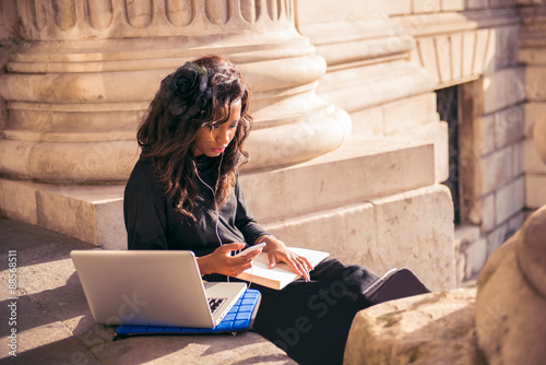 Photography Cool urban girl using mobile technology at the city of London.