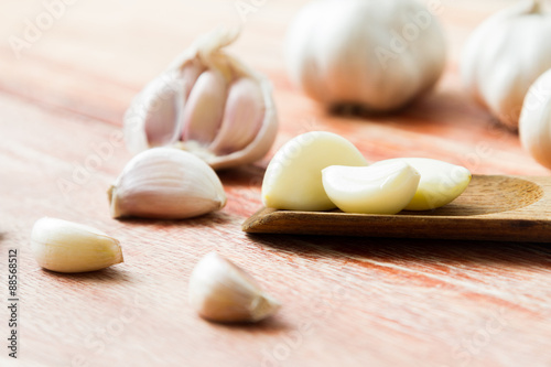 Organic garlic whole and cloves on the wooden background