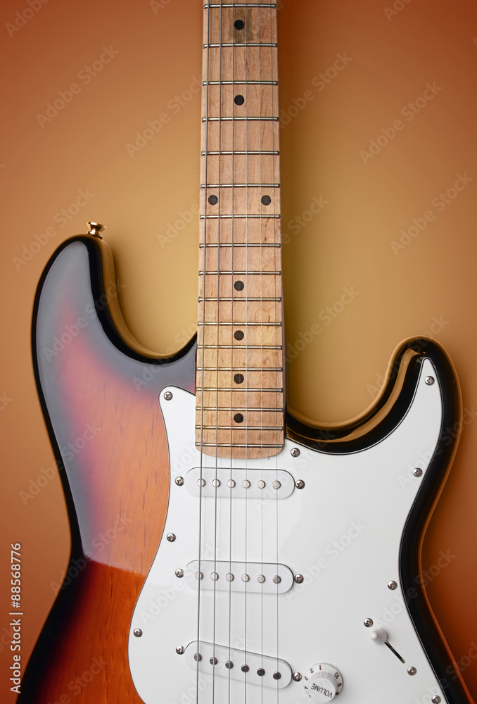 Electric guitar on orange background