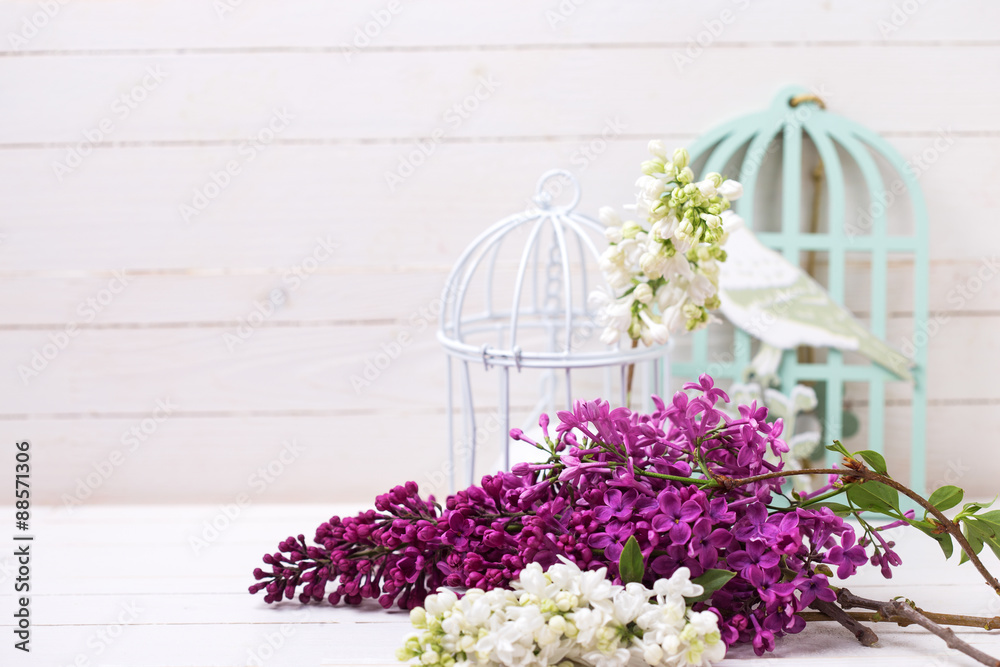 Lilac flowers  and candle on wooden background.