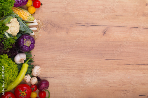 Vegetables on wood background with space for text