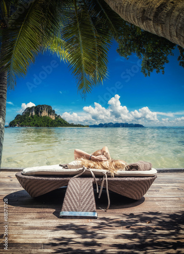  woman relaxing by the sea at tropical resort