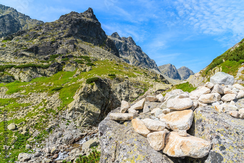 Pile of stones on rock in Starolesna valley in High Tatra Mountains on sunny summer day, Slovakia © pkazmierczak