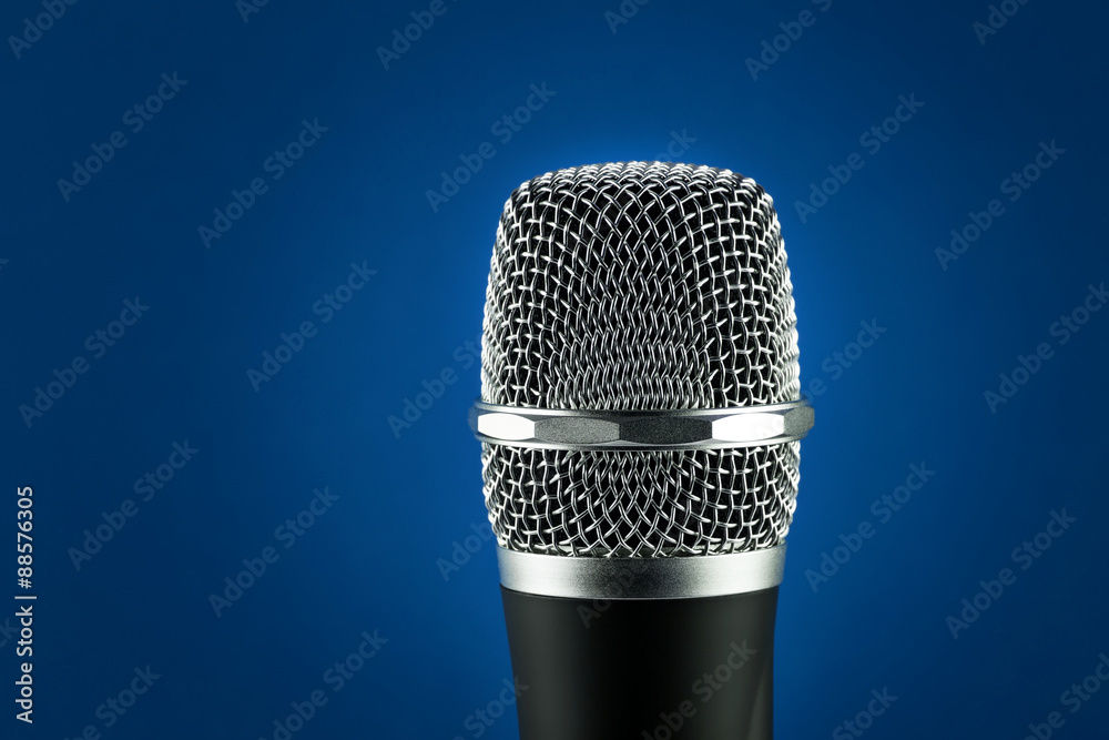 Wireless microphone on blue background Wireless microphone on blue background