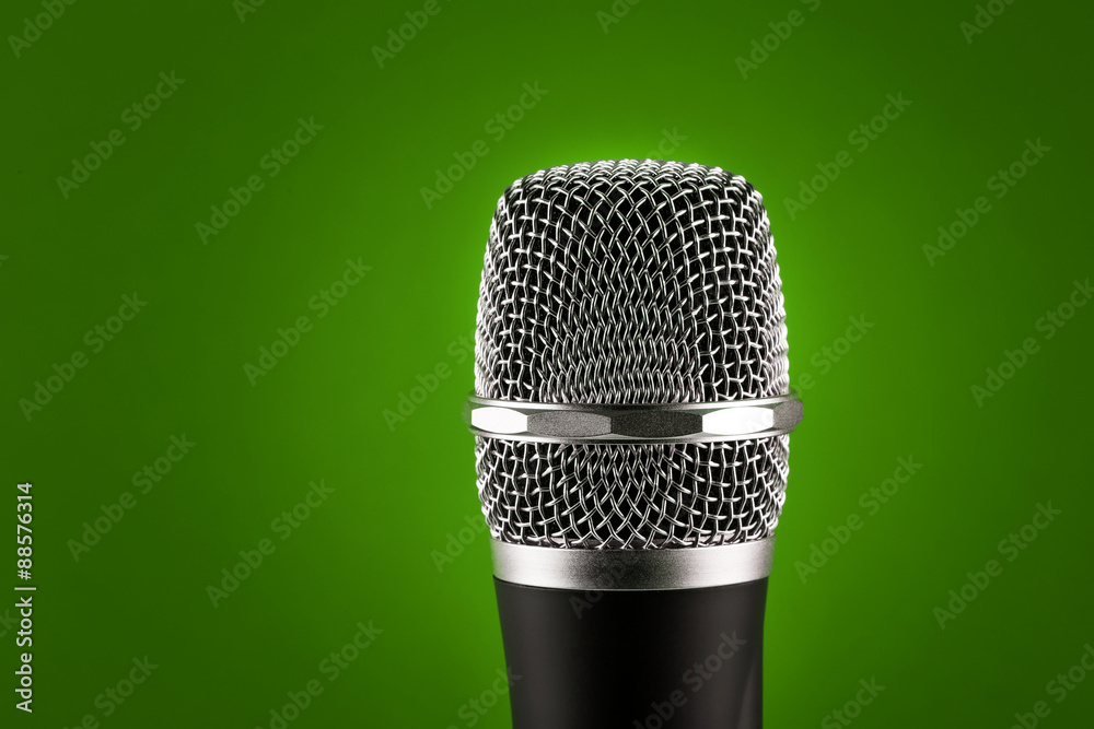 Wireless microphone on green background Wireless microphone on green background