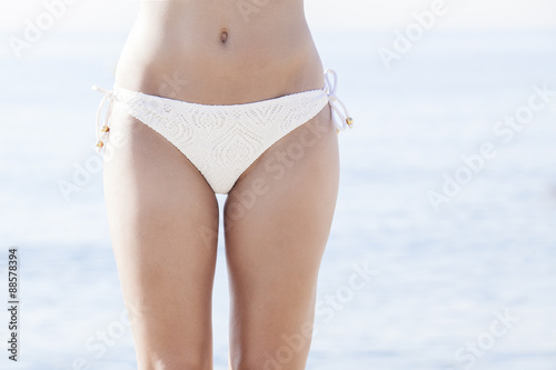 Front view of fit young woman in bikini. close up