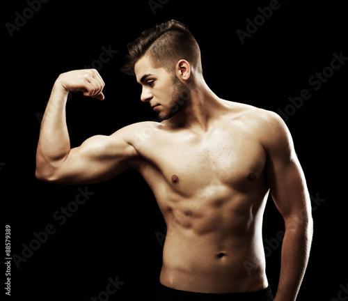 Muscle young man on black b...