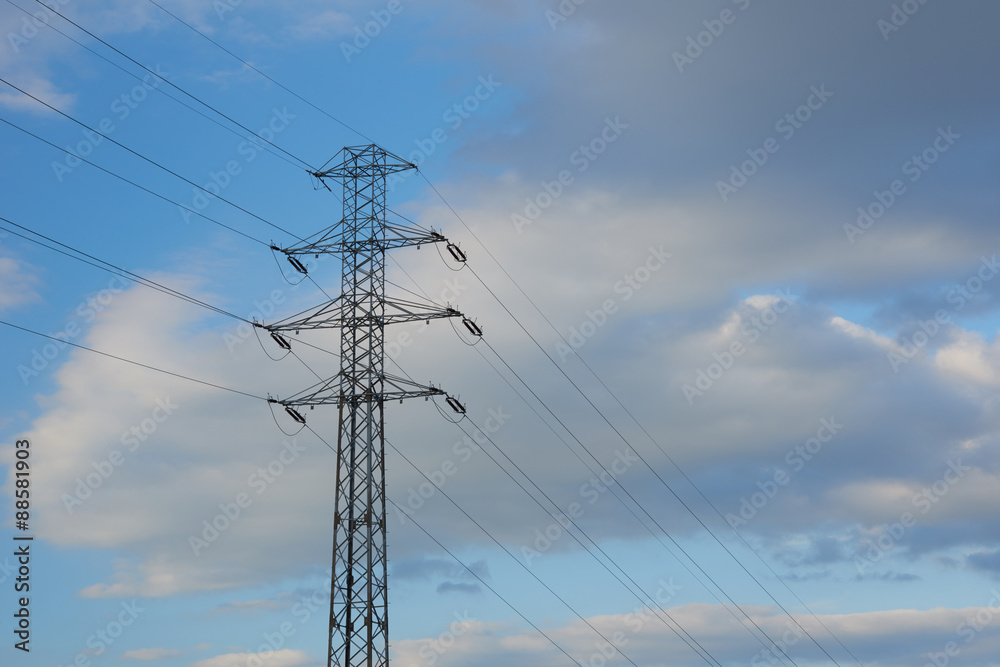 electricity transmission pylon silhouetted against blue sky electricity transmission pylon silhouetted against blue sky