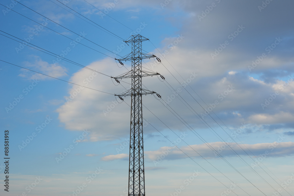 electricity transmission pylon silhouetted against blue sky electricity transmission pylon silhouetted against blue sky