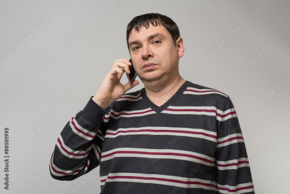 a man with a mobile phone on a gray background a man with a mobile phone on a gray background