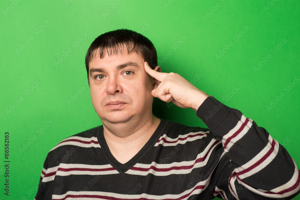 young guy thinks his finger to his temple young guy thinks his finger to his temple