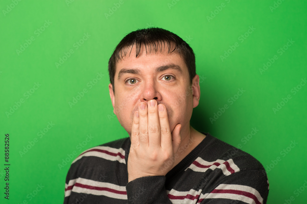 man closed his mouth with his hand, fear, quietly man closed his mouth with his hand, fear, quietly