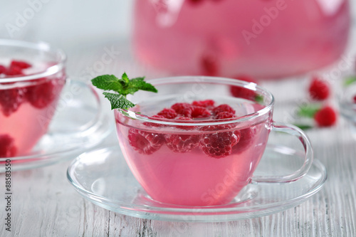 Wallpaper Mural Cups and teapot of raspberry drink with berries on wooden table close up Torontodigital.ca