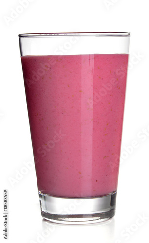 Glass of raspberry milk shake on light background