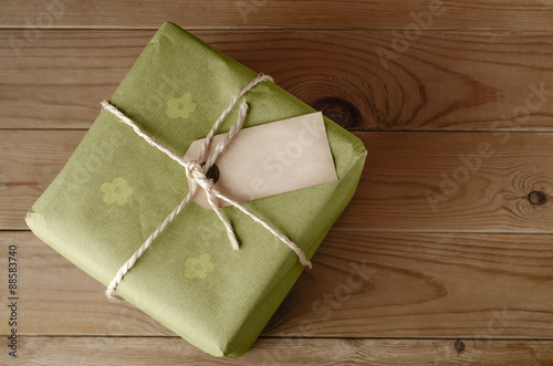 String Tied Parcel with Label and Green Floral Wrapping Paper