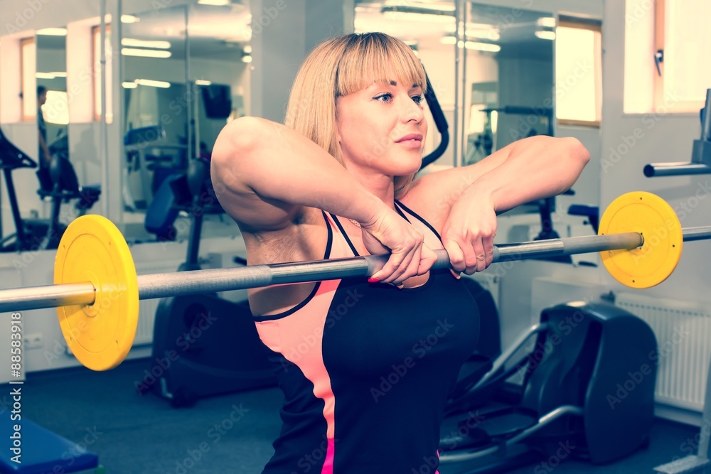 young girl engaged in bodybuilding in the gym young girl engaged in bodybuilding in the gym