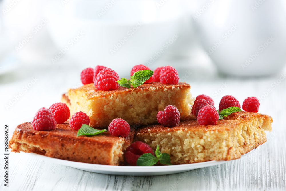 Fresh pie with raspberry in white plate on wooden table, closeup Fresh pie with raspberry in white plate on wooden table, closeup