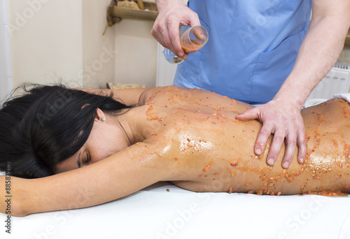 fruity young girl doing a massage in the beauty salon