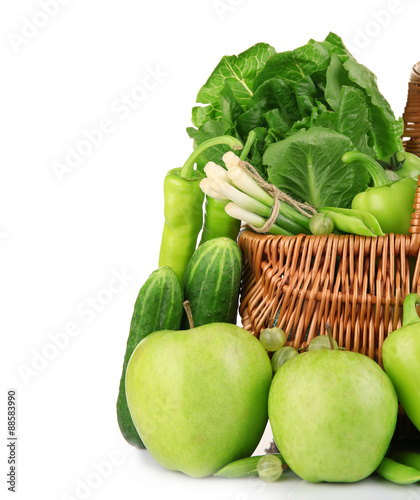 Fresh green food in wicker basket isolated on white