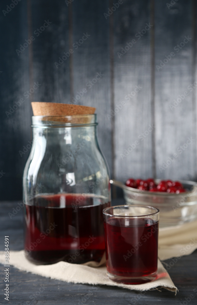 Sweet homemade cherry juice on table, on color wooden background Sweet homemade cherry juice on table, on color wooden background