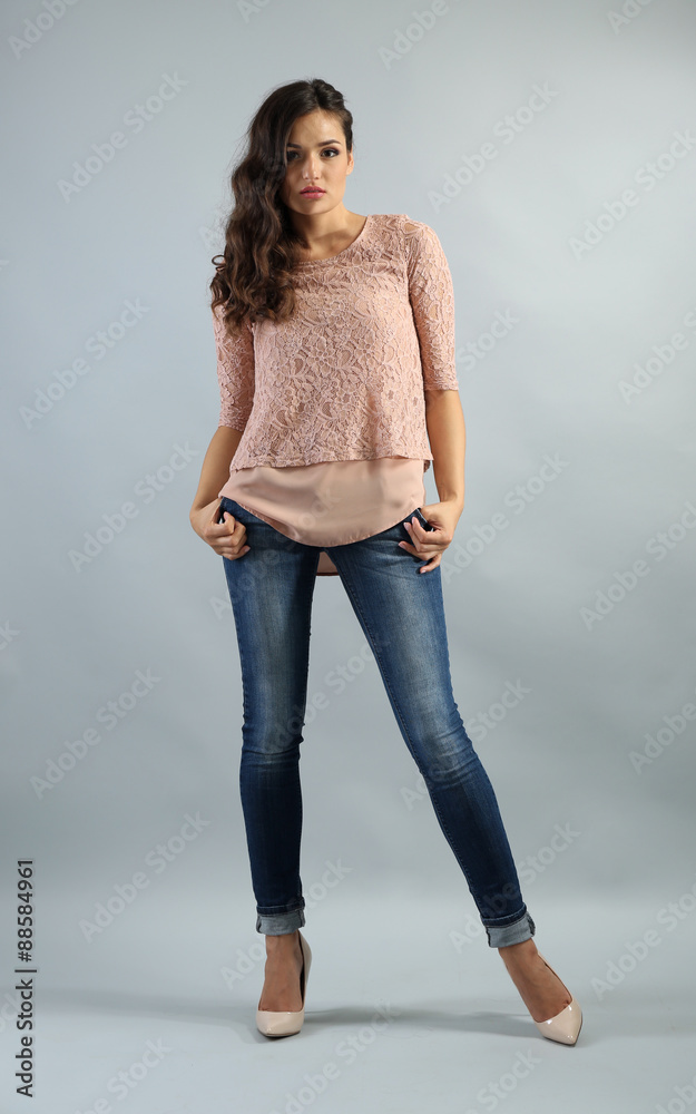 Young pretty woman on grey background Young pretty woman on grey background