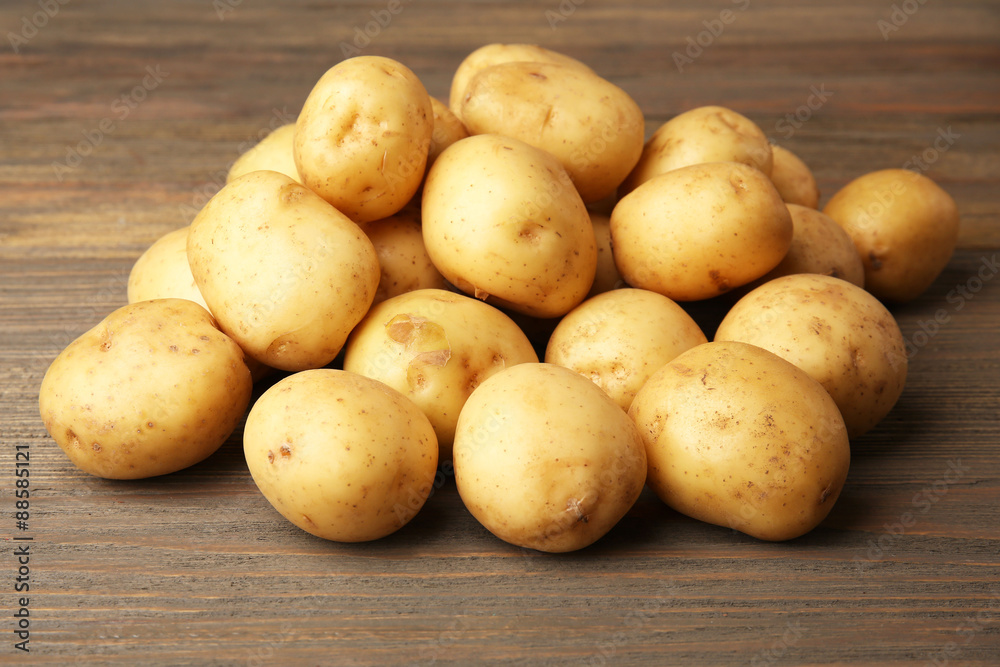 New potatoes on wooden background New potatoes on wooden background