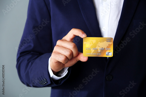 Businessman holding credit card,  close-up