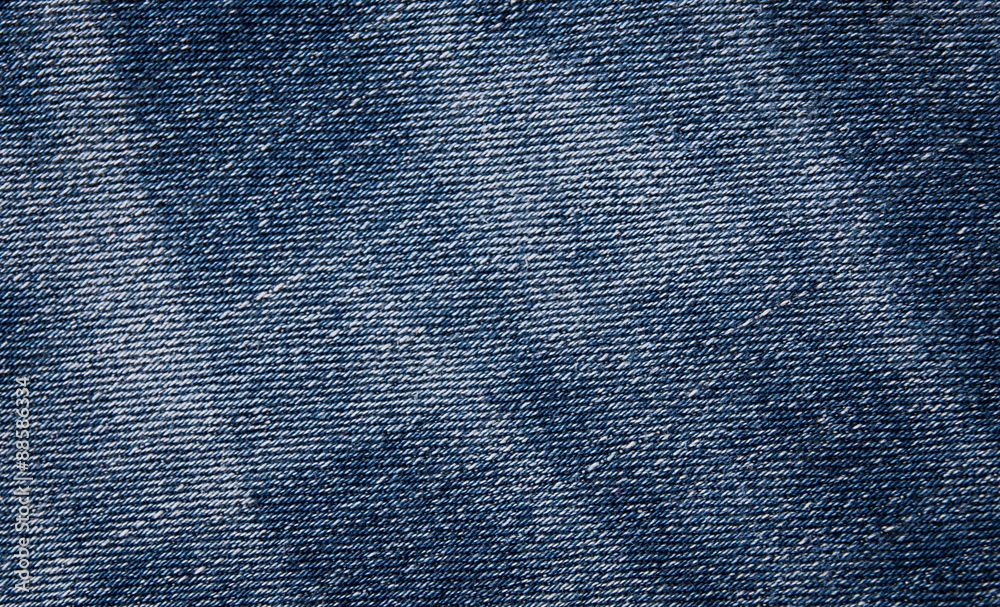 fashionable clothes. pile of jeans on a wooden background fashionable clothes. pile of jeans on a wooden background