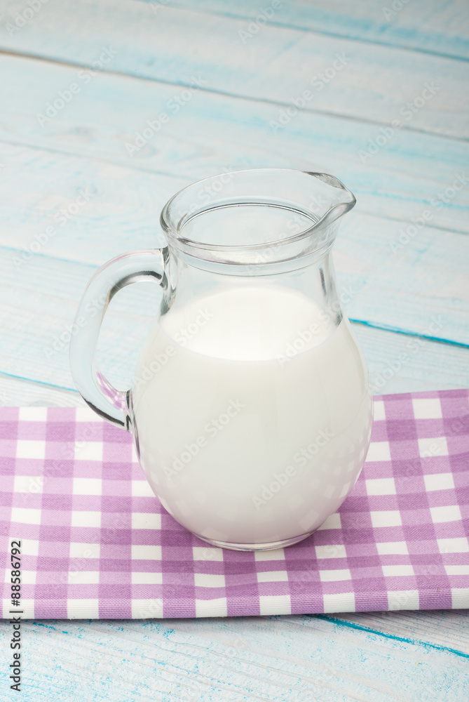 jug of milk on a purple checkered tablecloth jug of milk on a purple checkered tablecloth