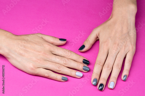 Delicate female hands with a stylish neutral manicure