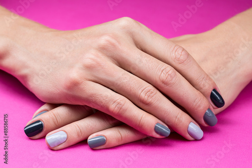 Delicate female hands with a stylish neutral manicure